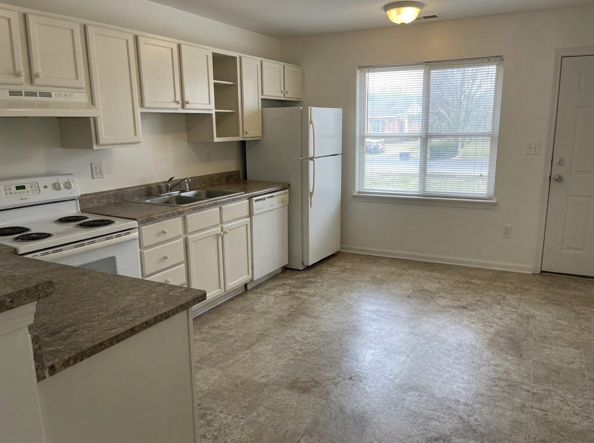 Same kitchen with clean counters, blinds and floors, and no trash