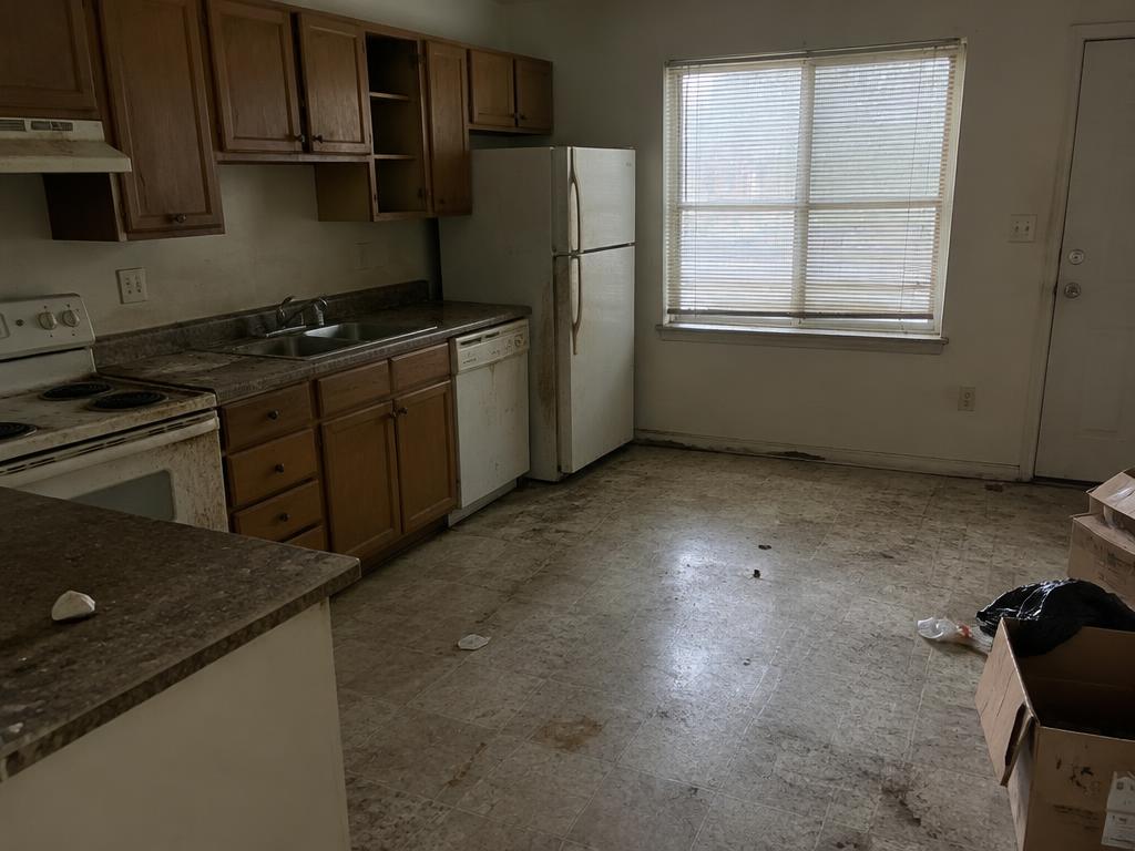 Kitchen before cleaning, with grimy counters and leftover trash